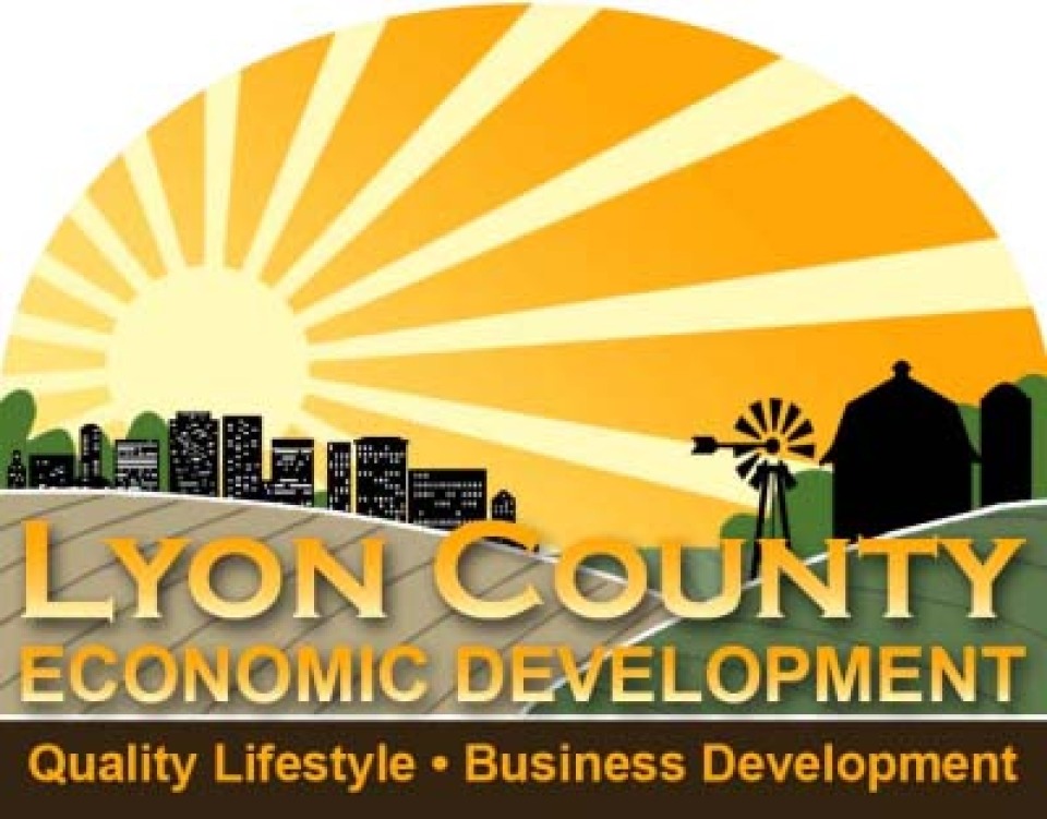 Lyon County Economic Development logo: sun rising on city and farm land.